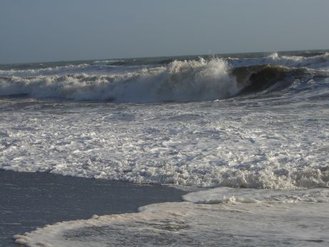 Photograph of a destructive wave breaking on a beach